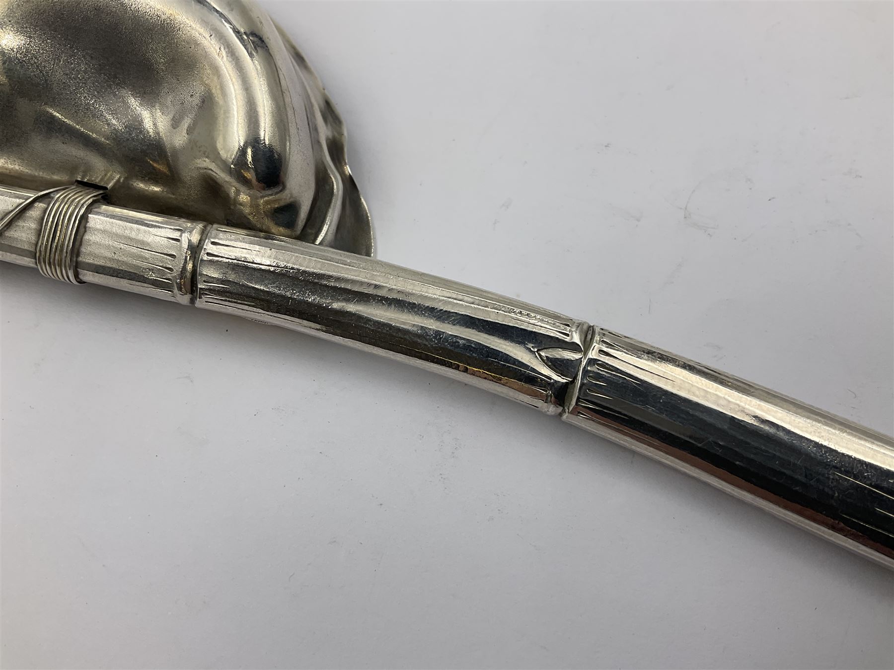 Mid/late 19th century Gorham silver serving spoon, circa 1863-1890, the bowl modelled as an oyster shell with silver gilt interior, affixed to the bamboo handle with silver twine, the bowl with marks for Gorham and impressed Sterling 330, L26.5cm
