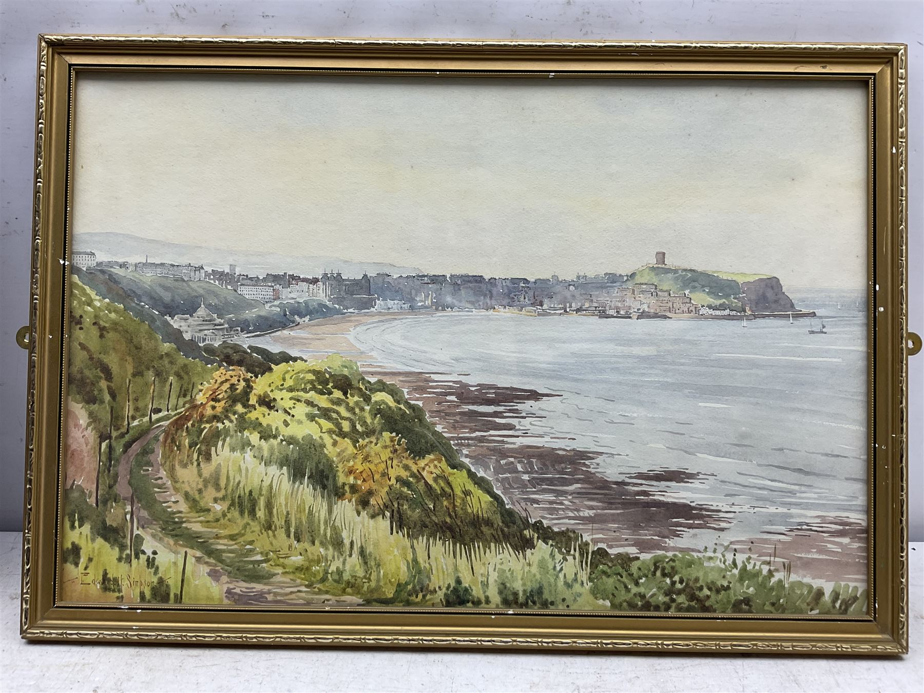 Edward H Simpson (British 1901-1989): 'Scarborough South Bay from Cliff Tops', watercolour signed, titled on label verso 35cm x 53cm;Tom S Hoy (British 20th century): Deck Chairs by the Ocean Room, Scarborough Spa, oil on board signed 30cm x 45cm; T Crawford (20th century): Steam and Sail Vessels, oil on board signed 40cm x 50cm (3)