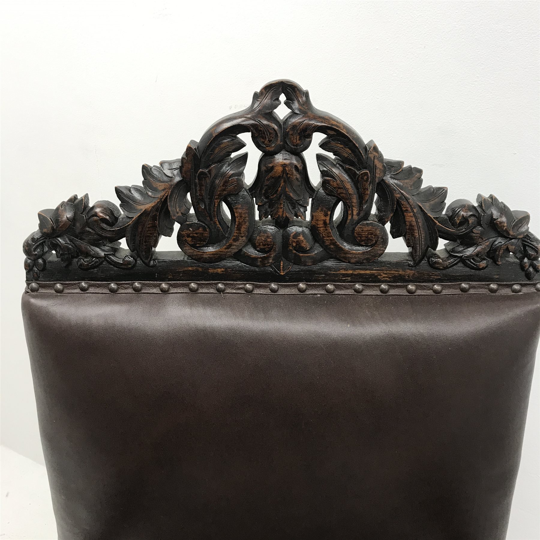 Jacobean style oak library chair, floral carved and pierced cresting rail, upholstered back seat and arms, barley twist supports (W68cm) and a similar oak hall chair, carved cresting rail and supports, upholstered back and seat (W52cm)