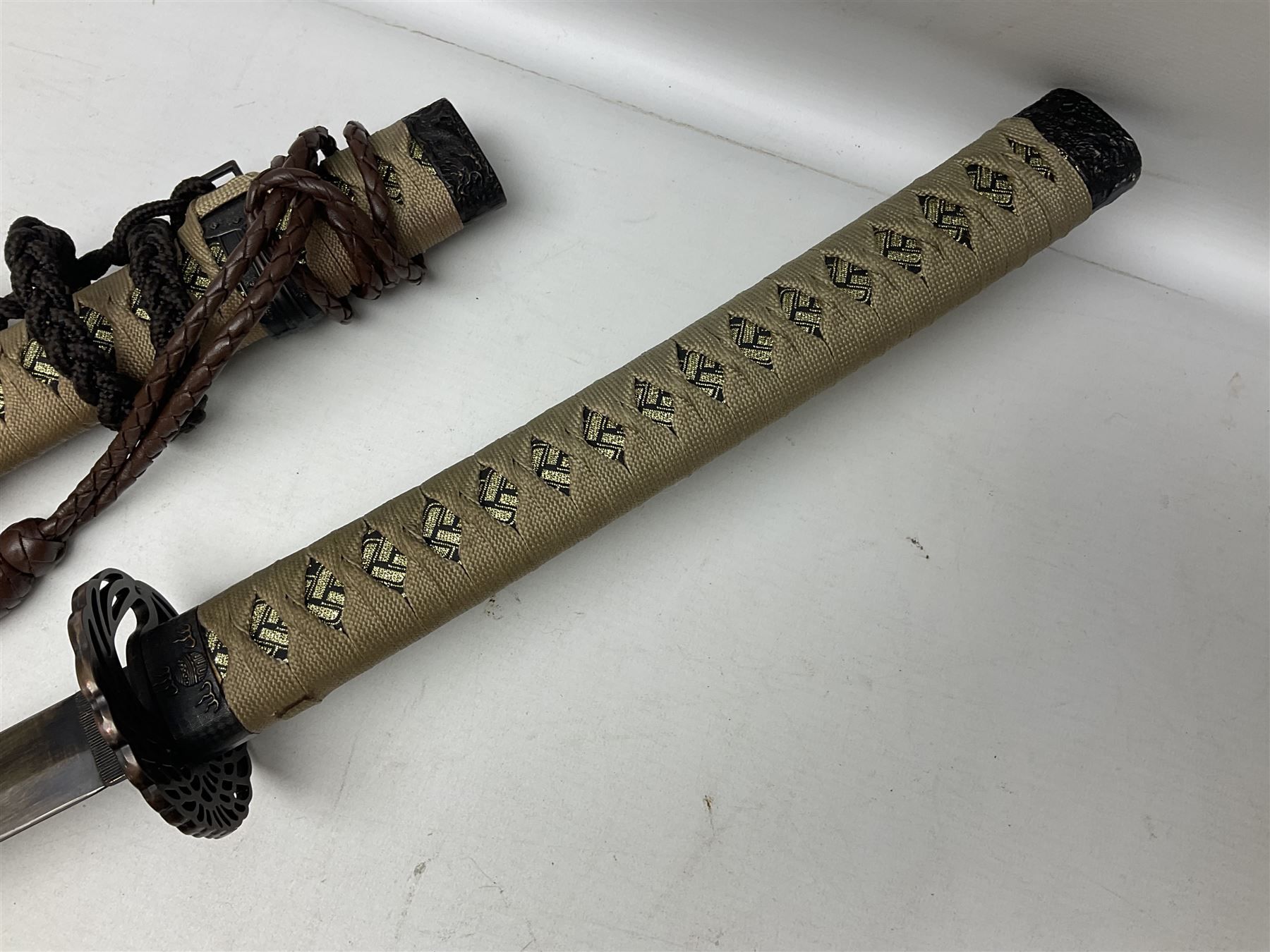 Reproduction Scottish officers basket hilt broad sword, the brass basket pierced with heart-shaped motifs lined with red lining, together with a reproduction Japanese Katana sword, longest L110cm