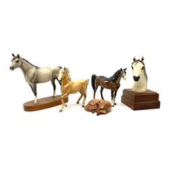 A group of assorted figures, comprising Beswick Arab 'Bahram' Connoisseur' horse, model no 1771, Beswick Palomino horse, model no 1261, Beswick brown Arab 'Xayal' horse, model no 1265,  Beswick fox, model no 1017, and a ceramic horse head on wooden plinth. 