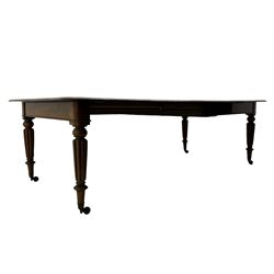 Early 19th century figured mahogany extending dining table, the rectangular top with moulded edge and rounded corners, pull-out action with three additional leaves, raised on turned and lobe carved supports with brass cup castors