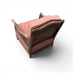 Early 20th century French style bergère conservatory suite, canework back and sides with red upholstered loose seat cushions, on cabriole feet