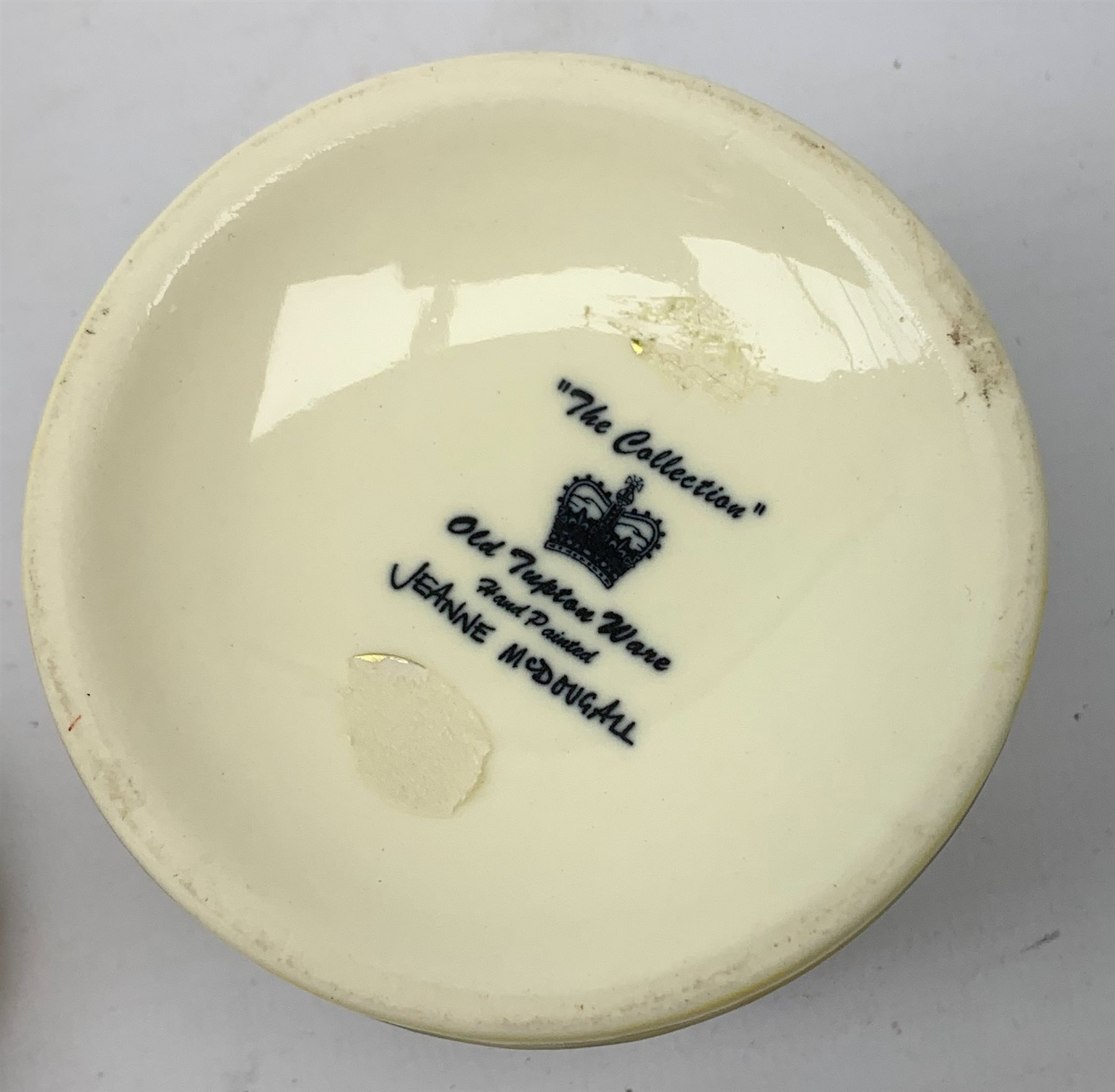 An Old Tupton Ware honey pot, of oval form with tube lined tendril decoration, the domed cover surmounted by a honey bee, with accompanying spoon, together with a pair of Old Tupton Ware vases, with tube lined sunflower decoration, H22cm, each with printed mark to base.