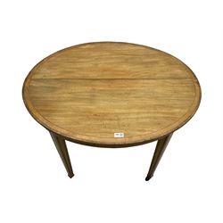 Edwardian mahogany and satinwood banded oval table, on square tapering fluted supports with brass and ceramic castors