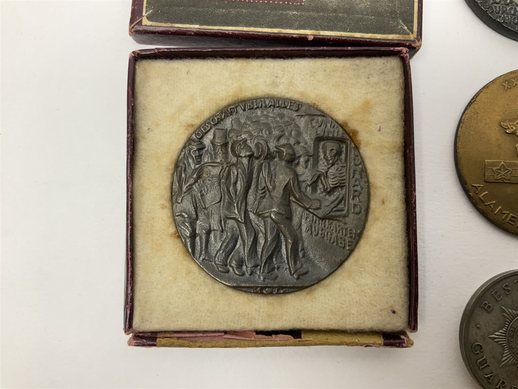 RMS Lusitania iron medallion dated 5th May, 5.5cm diameter, boxed with St Dunstan's Blinded Soldiers Profit paperwork; another unboxed similar Lusitania medallion; 30th Corps Alamein Cuxhaven medallion; Battle of Jutland 1916 silver memorial pendant; Navajo Code Talkers medallion 2000; and five other military related medallions
