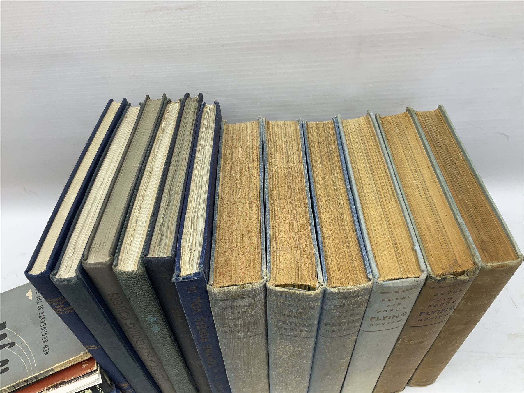 Aircraft of the Fighting Powers. Five volumes. 1940-44 including two copies of volume three; Royal Air Force Flying Review. Six volumes. 1956-63. Uniformly bound in blue cloth with gilt RAF crest to front covers; and ten other books of aircraft and aeronautica interest.