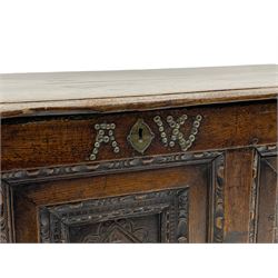 18th century oak coffer, moulded hinged lid over triple panelled front, each panel carved with flower head lozenge, stud work 