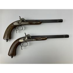 Pair of Muller & Lyon 11mm (approx. .42 cal.) percussion target pistols each with 24.5cm rifled octagonal and fluted barrel, plain action and hammer, unchequered walnut stock with inverted crown shaped butt plate and hooked trigger guard, no set trigger or half cock safety, numbered 1 & 2 on top of breech, L42cm overall; in baize lined fitted walnut case with all accessories including miniature copper powder flask, scissor action bullet mould, nipple key with screw-driver attachment, turned hardwood mallet and graduated pair of lidded boxes, brass rammer, cleaning rod etc, case L55.5cm