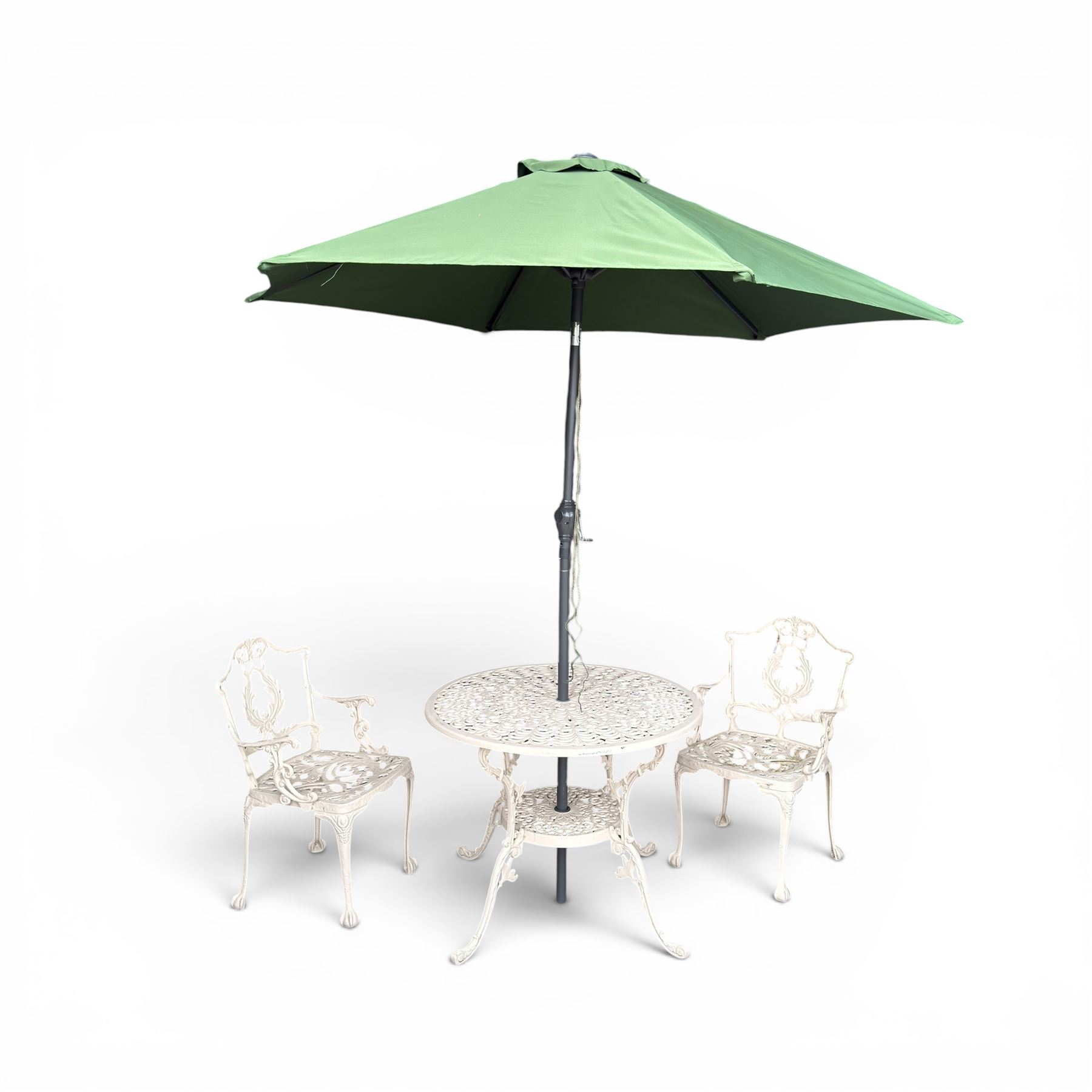 Victorian design cast aluminium garden table and twin armchairs featuring a pierced floral wreath splat, over a stylised scrolling acanthus leaf seat, including parasol