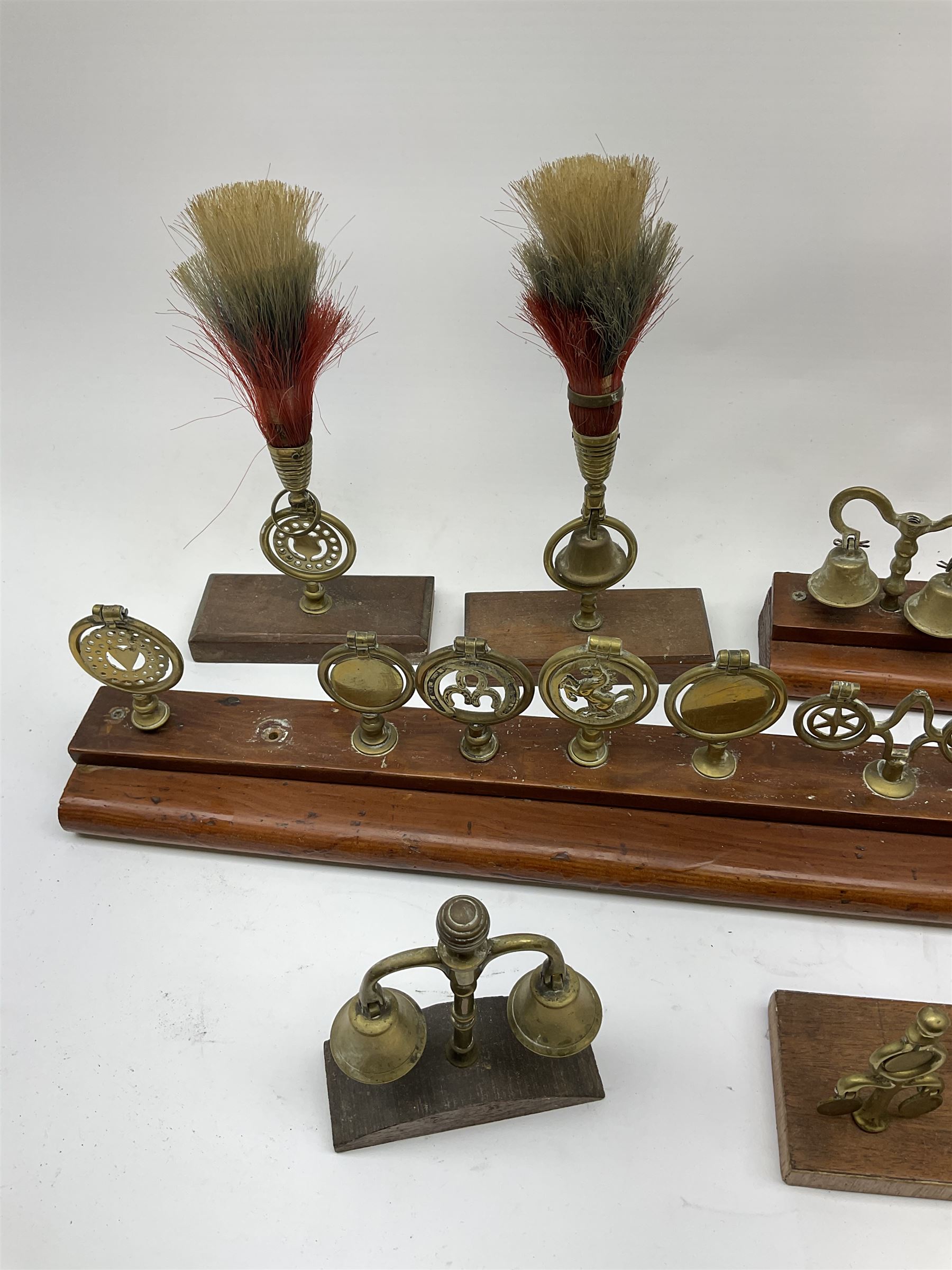 Brass horse terrets, many mounted on wood, including four examples with plumes
