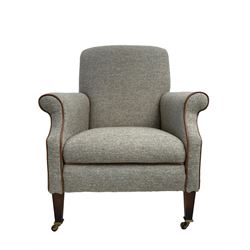 Interiors at Nine to Eleven - Edwardian design armchair, traditional shape with rolled arms, upholstered in 'Harris Tweed' fabric with leather piping, raised on square taping supports with castors