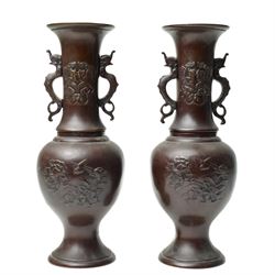 Pair of Japanese bronze vases, with twin handles in the form of dragons, decorated with fl...