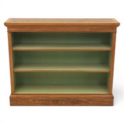Traditional walnut small bookcase, with projecting cornice above a green painted interior,...