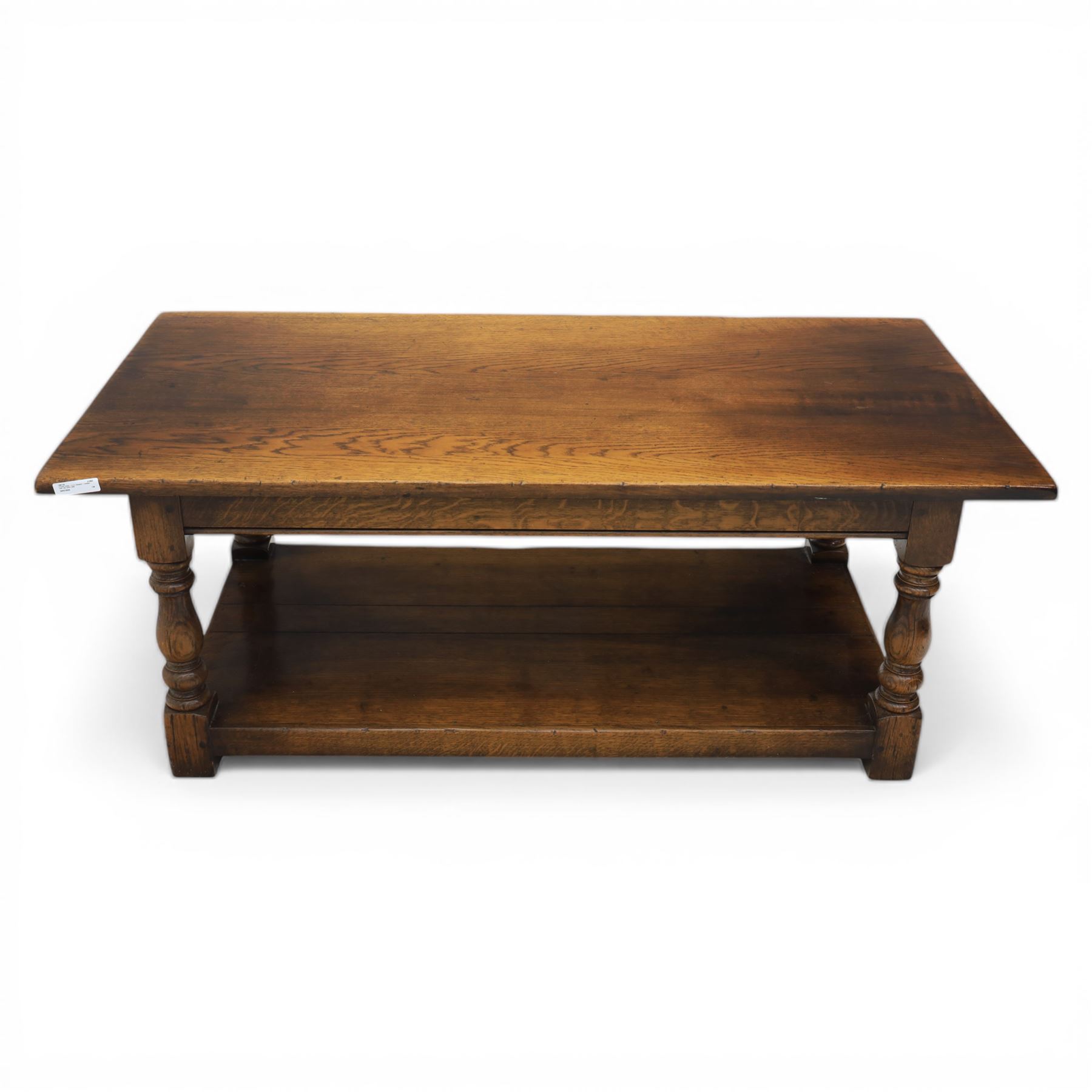 Oak coffee rectangular table, in the manner of Titchmarsh & Goodwin, raised on turned supports united by a full length undertier