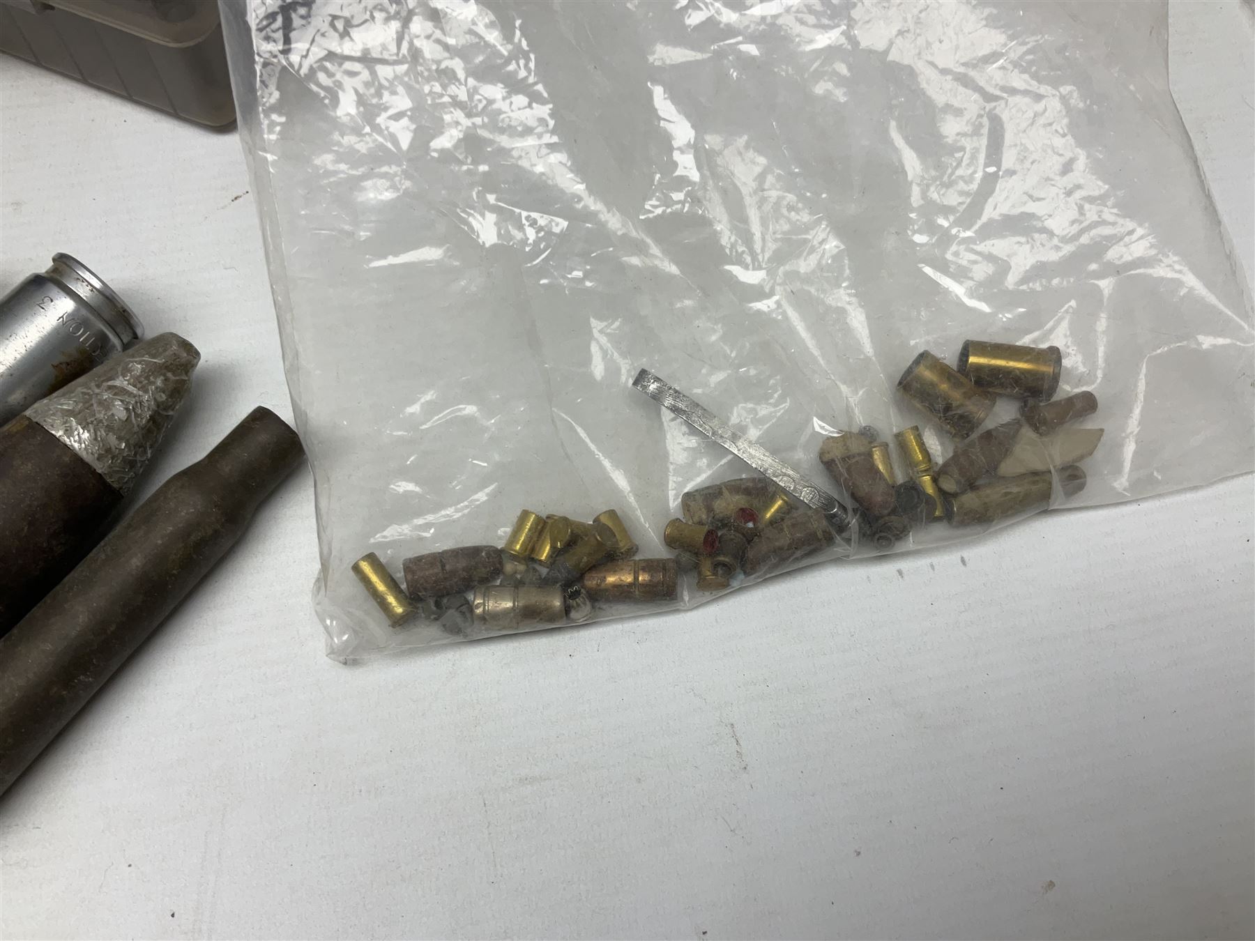 Assorted militaria including ten leather or canvas cartridge and other belts, maroon beret with 17th Lancers cap badge, modern bullet mould, leather and brass shot flask, two knives, shell cases, boomerang etc; in tin deed box