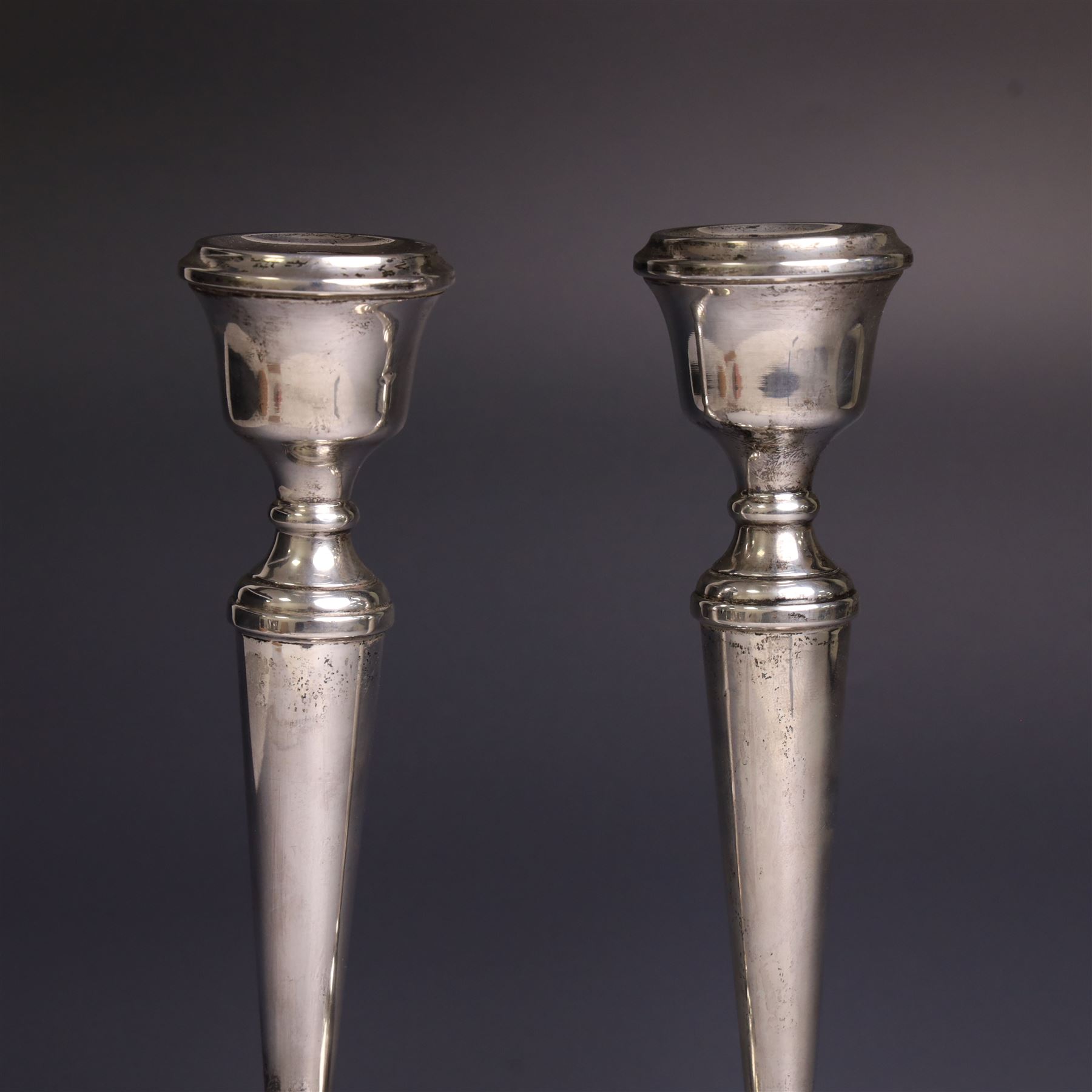Pair of late 20th century silver candlesticks, each with tapering stem and upon circular beaded weigthed foot, hallmarked A T Cannon Ltd, Birmingham 1970, H21cm