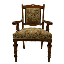 Late Victorian walnut elbow armchair, moulded frame and turned supports, upholstered seat and back in heraldic patterned fabric