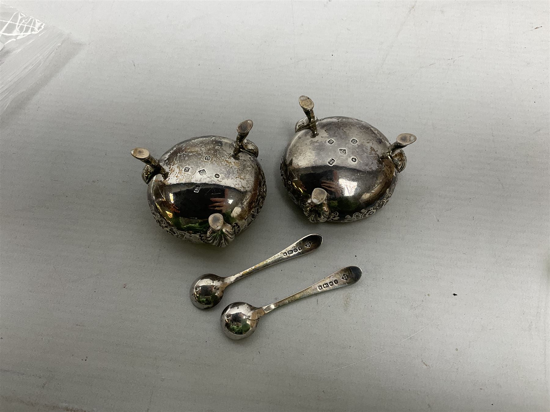 Pair of Victorian silver table salt cellars of cauldron form with gilt interiors, together with accompanying salt spoons, hallmarked Martin, Hall & Co, Sheffield 1879, total weight approx 100.5g