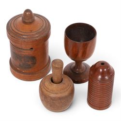 Group of treen, comprising, Mauchline ware coin box, box modelled as pear, egg cup, butter stamp, bell push, sewing implement, weaving tool, and box modelled as book