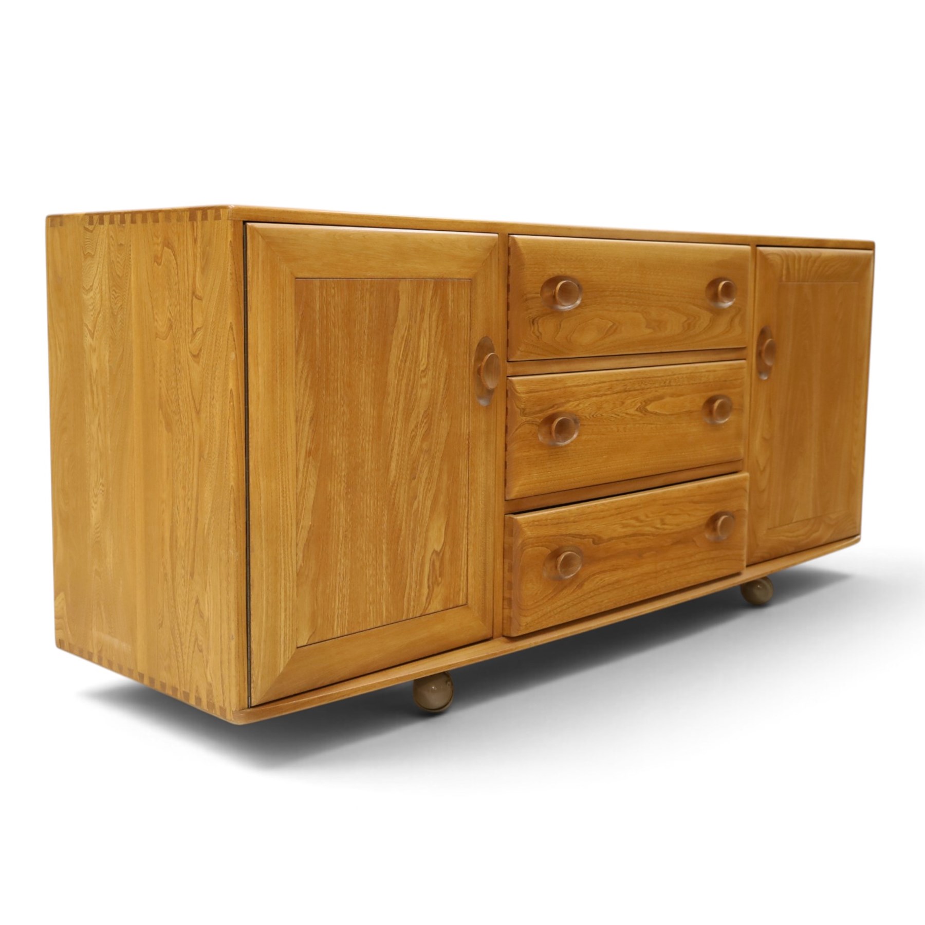 Ercol - mid-20th century light elm and beech Windsor 'model 455' sideboard, rectangular top over three central drawers flanked by cupboards, on castors