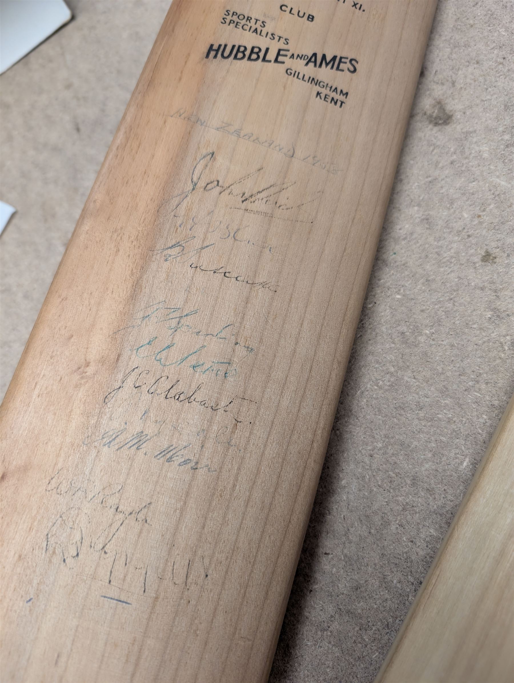 Two signed cricket bats, with signatures including Colin Cowdrey