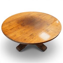 Early 20th century oak centre table, the large circular top raised on a squared and turned baluster pedestal, terminating to four splayed supports