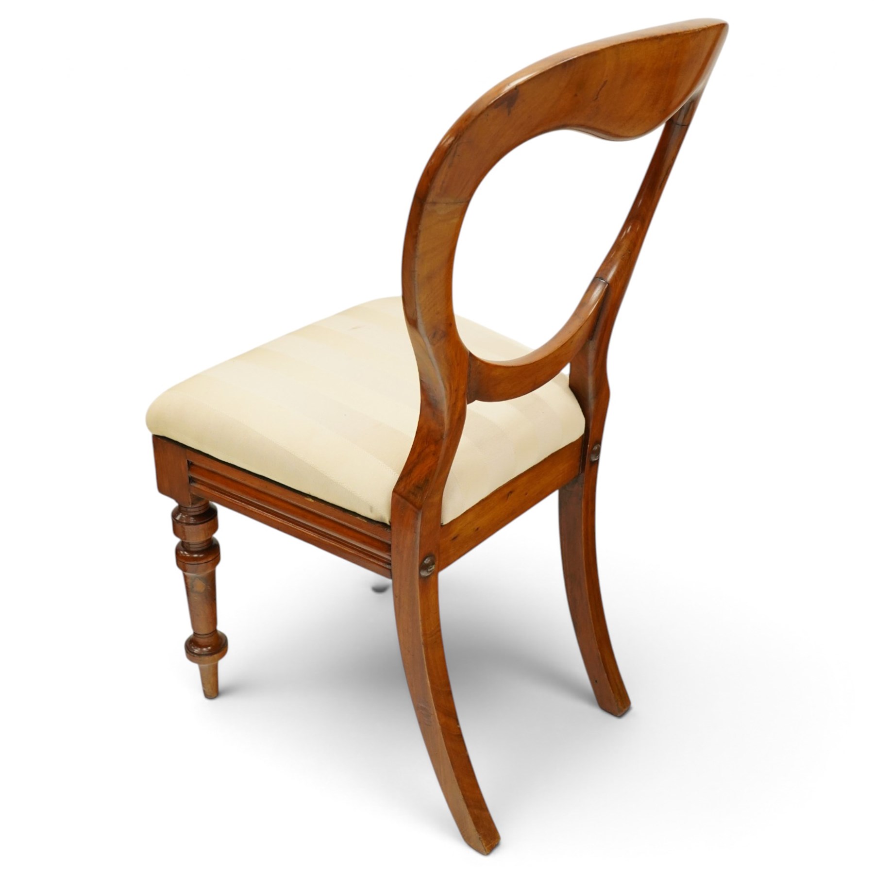 Set of twelve Victorian walnut balloon-back dining chairs, shaped open back over seats upholstered in striped ivory fabric, moulded seat rail above turned and tapering suppors