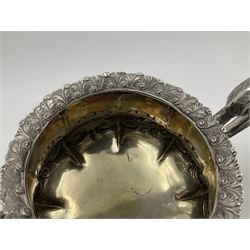 Victorian silver three piece tea service, comprising teapot, twin handled open sucrier, and milk jug, each of bellied form with acanthus capped scroll handles, the sides embossed with alternating scroll edged vacant panels and panels containing a pair of birds, upon four palmette feet, the teapot with ivory insulators to handle, and bird finial to the hinged domed cover, hallmarked William Hunter & Son, London 1861, teapot H19cm, including handles sucrier H13.5cm, including handle milk jug H12cm

This item has been registered for sale under Section 10 of the APHA Ivory Act