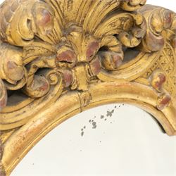 19th century Italian Baroque Revival carved giltwood and gesso wall mirror, the large acanthus leaf pediment flanked by C-scrolls and further acanthi motifs, enclosing a shaped arch plate with moulded slip, flanked by down-scrolls of acanthi with emerging flowering branches, on a stepped base