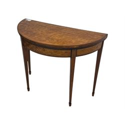Edwardian satinwood inlaid demi-lune card table, hinged fold over green baize lined interior, raised on square tapered supports with spade feet  