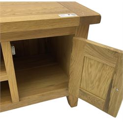 Light oak media stand, two open shelves flanked by cupboards