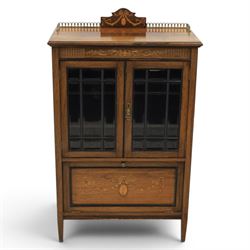 Druce & Co - Edwardian inlaid cabinet, galleried topwith inlay and brass galleried top, inlaid frieze above twin bevel glazed doors revealing a shelved interior, the lower section with fall front cupboard