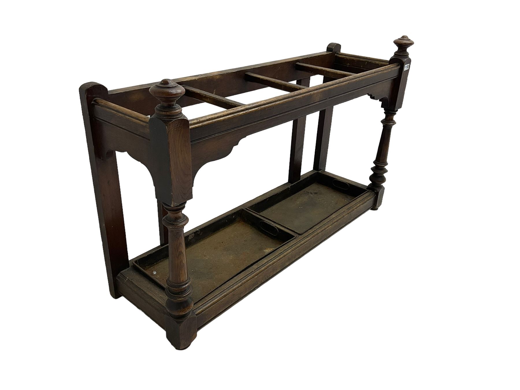 Edwardian oak hallway stick and umbrella stand, four divisions on turned supports, with metal tray liners and various sticks