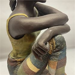Composite bronzed sculpture, modelled as a woman sitting cross legged upon a wooden plinth, signed S.Tozer, H51cm