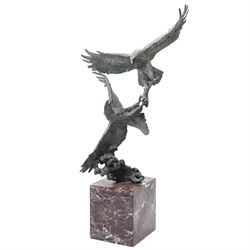 Bronze sculpture, modelled as two eagles fighting in flight, signed Milo, mounted upon a l...