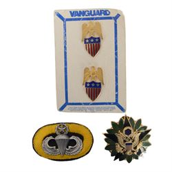 Selection of US army, navy  and air force insignia together with US Army WWII I.D. Tags on chain with British coins