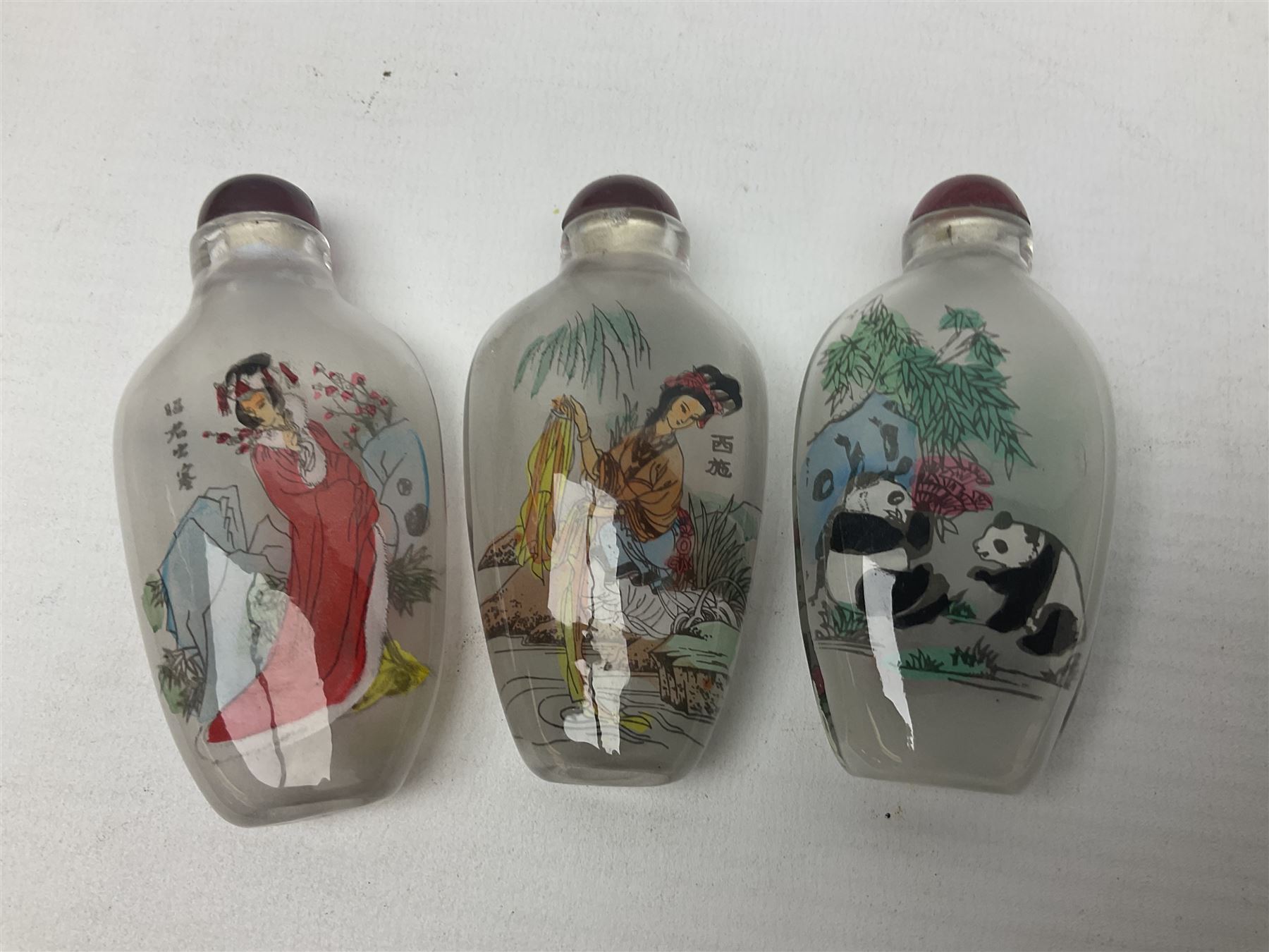 Seven Chinese glass snuff bottles painted with figures and animals, together with three wood mounted bone examples