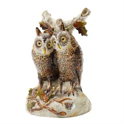 Continental figural group of two owls, possibly by Ernst Bohne & Söhne, modelled in a naturalistic setting, H25cm; together with a model delft charger (2)