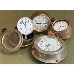 Group of four early automobile dashboard timepiece clocks, three in brass cases and one in...