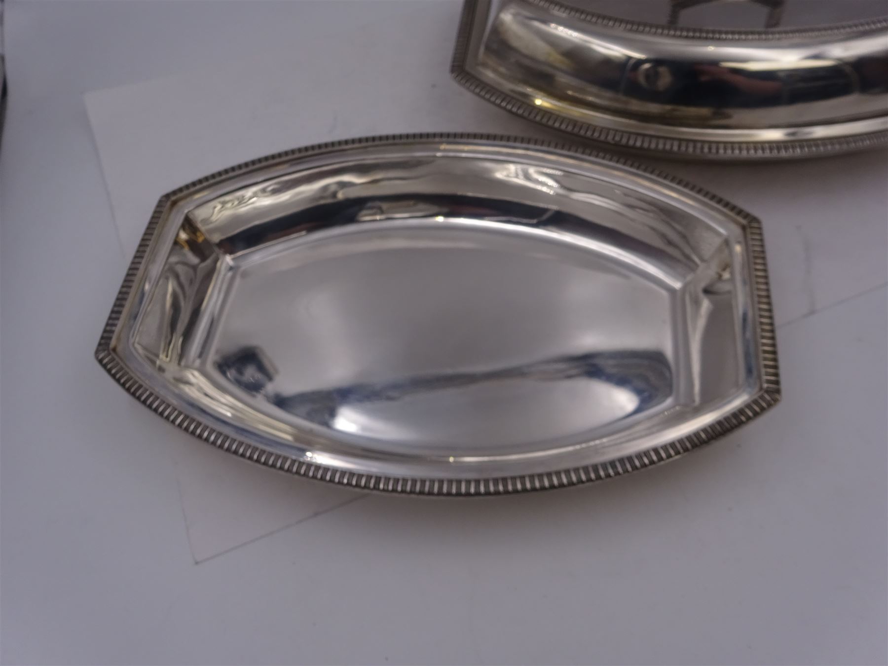 Pair of 1930s silver serving dishes with covers, each with removable handles, hallmarked Barker Brothers Silver Ltd, Birmingham 1935, L27.5cm, H12cm