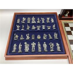 Danbury Mint 'The Fantasy of the Crystal' chess set consisting of mythical pewter chess pieces within a wooden case with chess board lid, together with 16 additional chess pieces in a wooden display case.