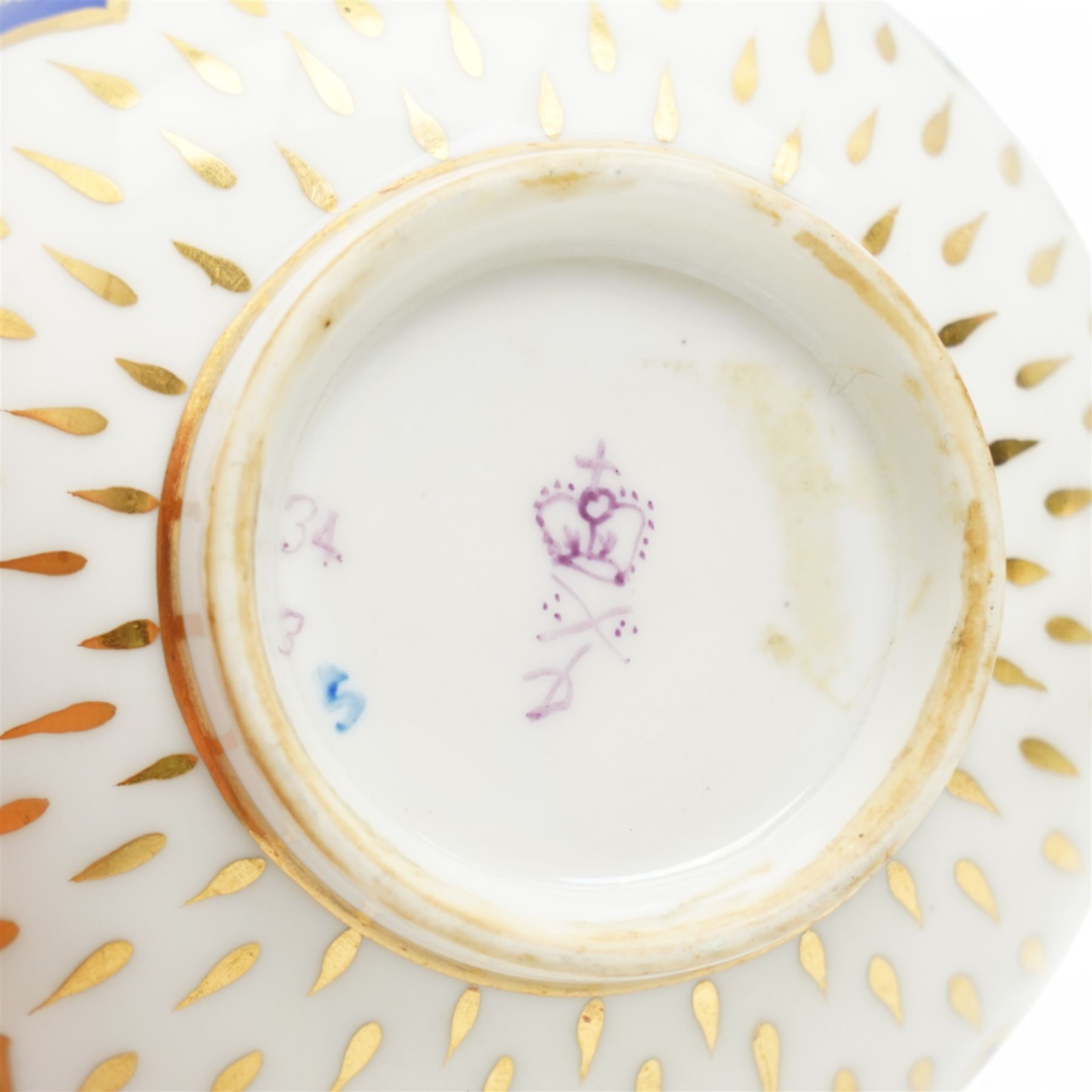 Two sets of Derby tea wares, comprising two saucers, teacup and small bowl, decorated in blue and white, with teardrop and swag motifs, heightened with gilt, one set marked pattern no. 34,  with late 18th century D mark in puce, the other with crown, D mark and crossed batons in puce (4)