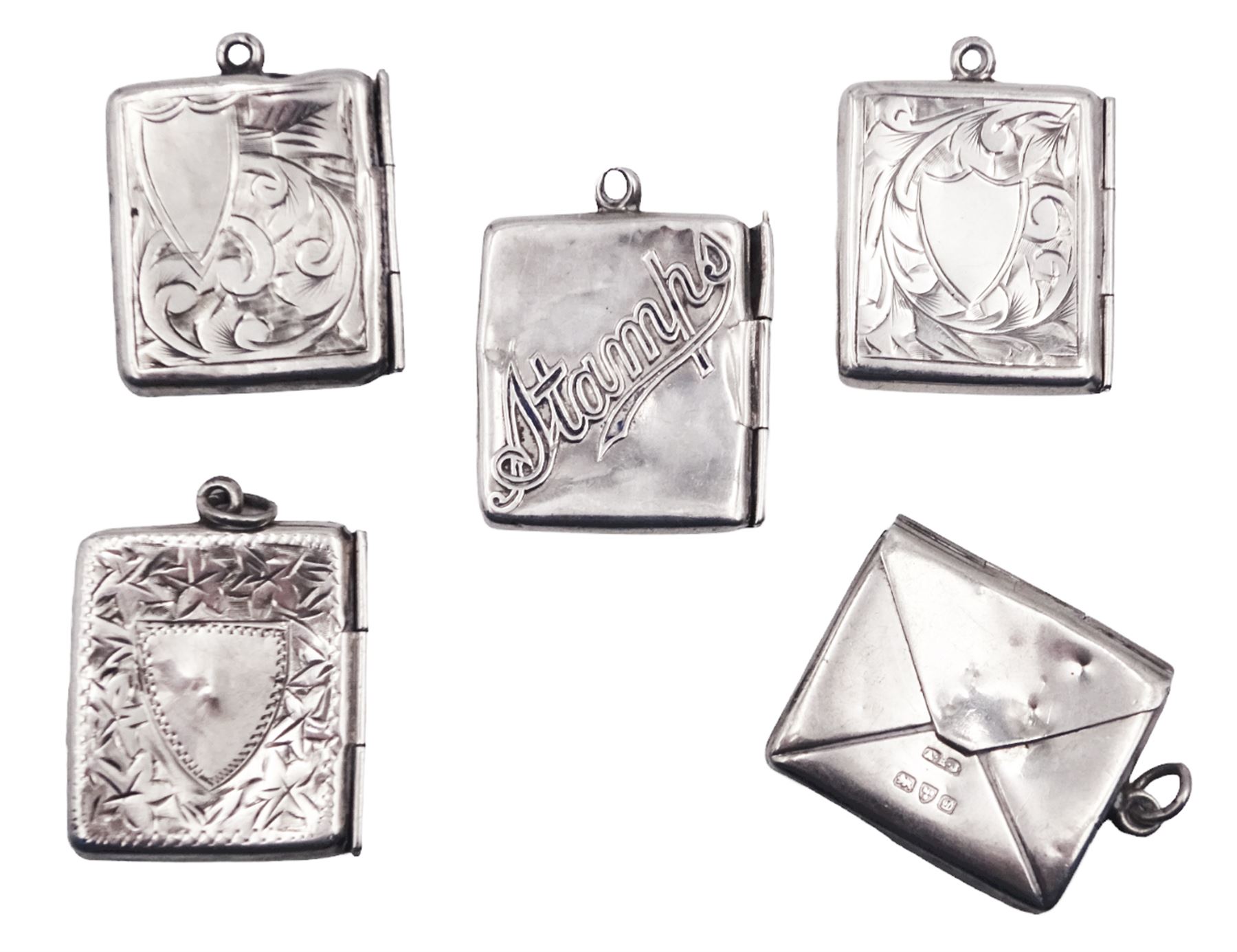 Five early 20th century silver stamp holders modelled in the form of envelopes, comprising three foliate engraved examples, and two plain examples, one with applied detail 'Stamps' verso, hallmarked Albert Ernest Jenkins, (makers mark to one example worn and indistinct),  Chester 1904, 1906, 1908 and 1912, approximate total weight 0.60 ozt (18.6 grams)