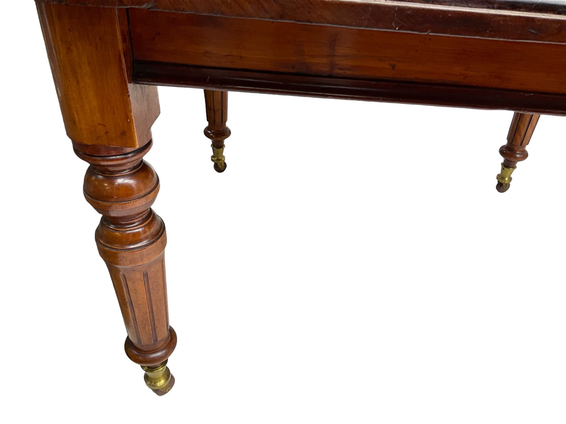19th century mahogany extending dining table, moulded rectangular top with rounded corners, on turned and fluted supports with brass and ceramic castors
