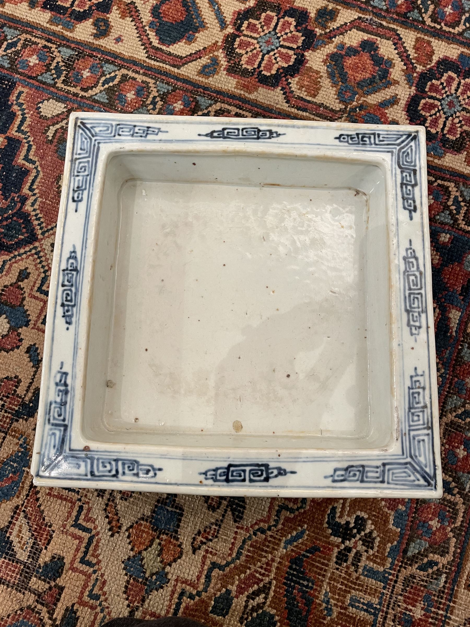 19th century Chinese blue and white planter and stand, each of square slightly tapering and flared form, the planter decorated with figures and precious objects between stylised foliate borders, the stand decorated with landscapes beneath a lipped rim with cell band, planter H28cm D25.5cm, stand H7cm D26cm