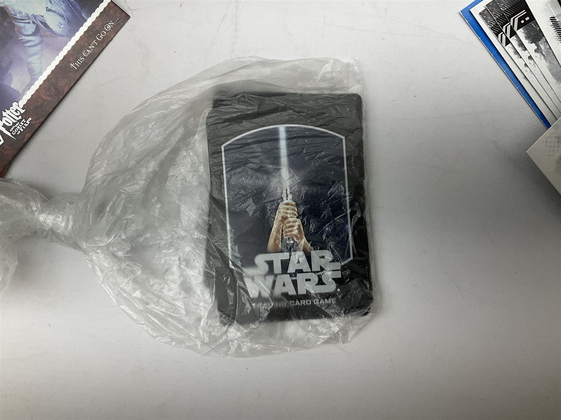 Collection of Star Trek collectors cards to include ‘Alternate Universe’ and ‘Q Continuum’ series, Star Wars cards etc housed in white album
and Harry Potter, Disney and other loose examples