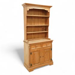 20th century stripped pine dresser, the open rack with dentil frieze and fixed shelves ove...