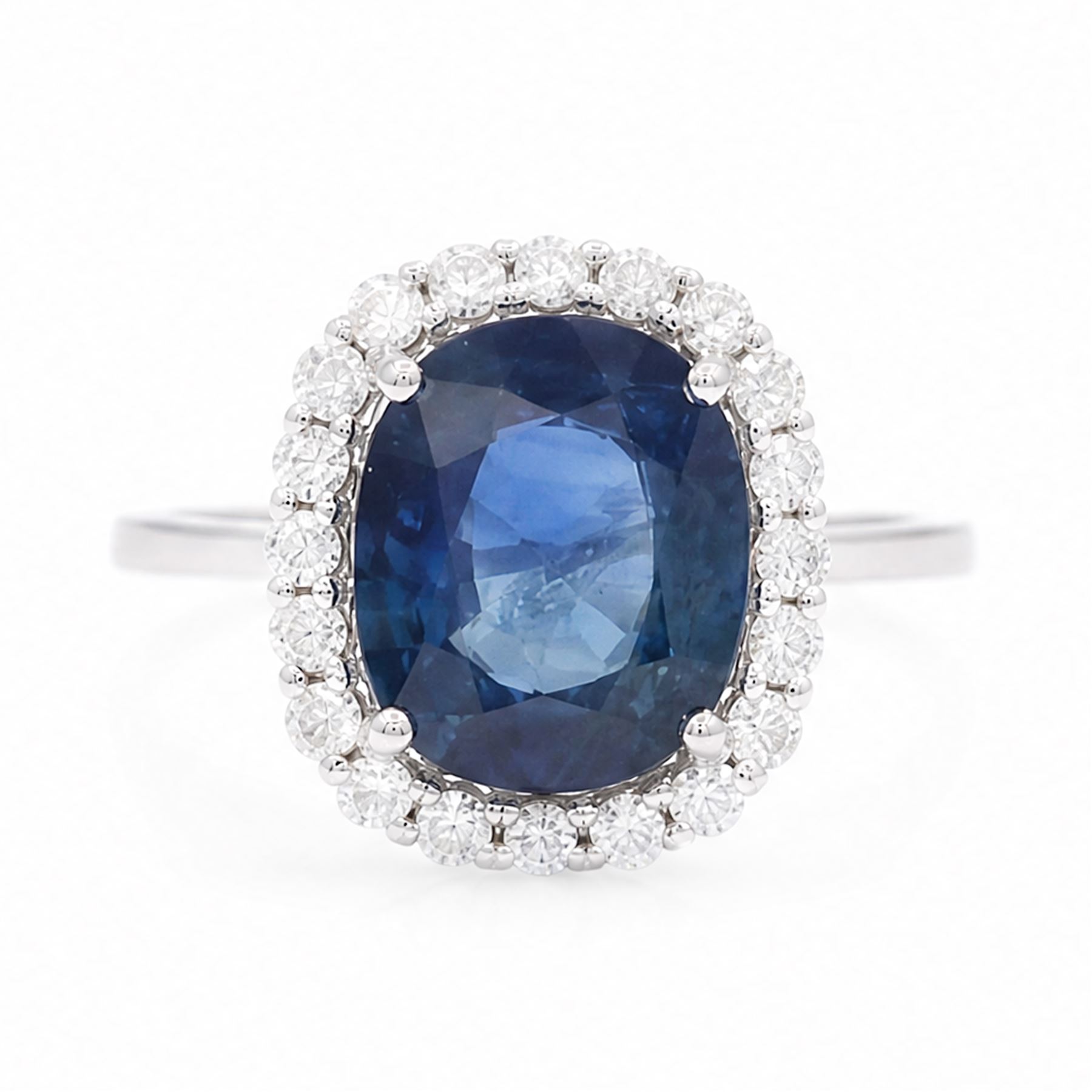 18ct white gold sapphire and diamond cluster ring, single cushion cut sapphire of approx 4.20 carat, surrounded by twenty round brilliant cut diamonds, stamped 750, total diamond weight approx 0.50 carat