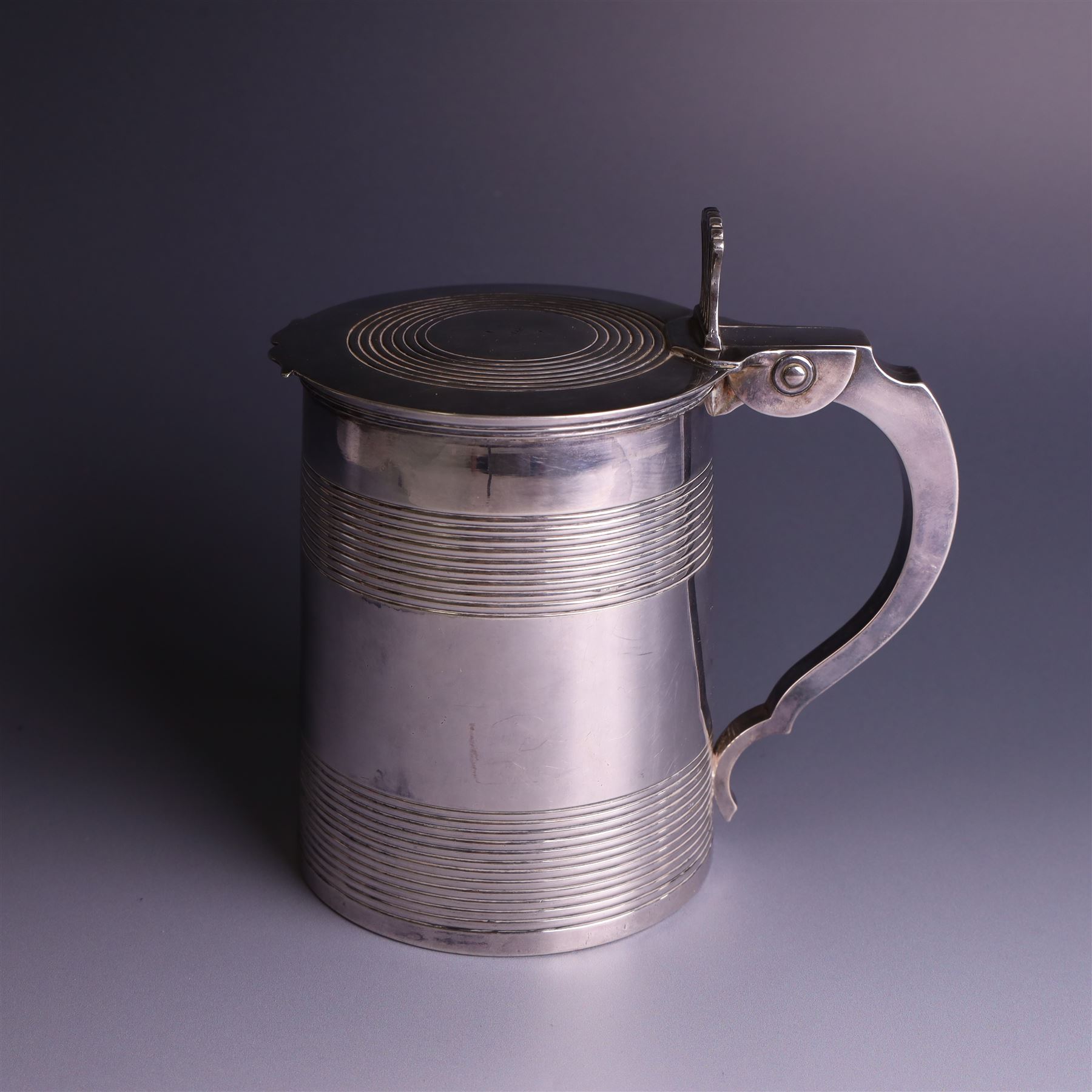 George III silver lidded tankard, with two ribbed bands to the cylindrical body, the hinged lid with concentric circle to cover and pierced thumbpiece, hallmarked Charles Fox I, London 1816, including thumb piece H16cm